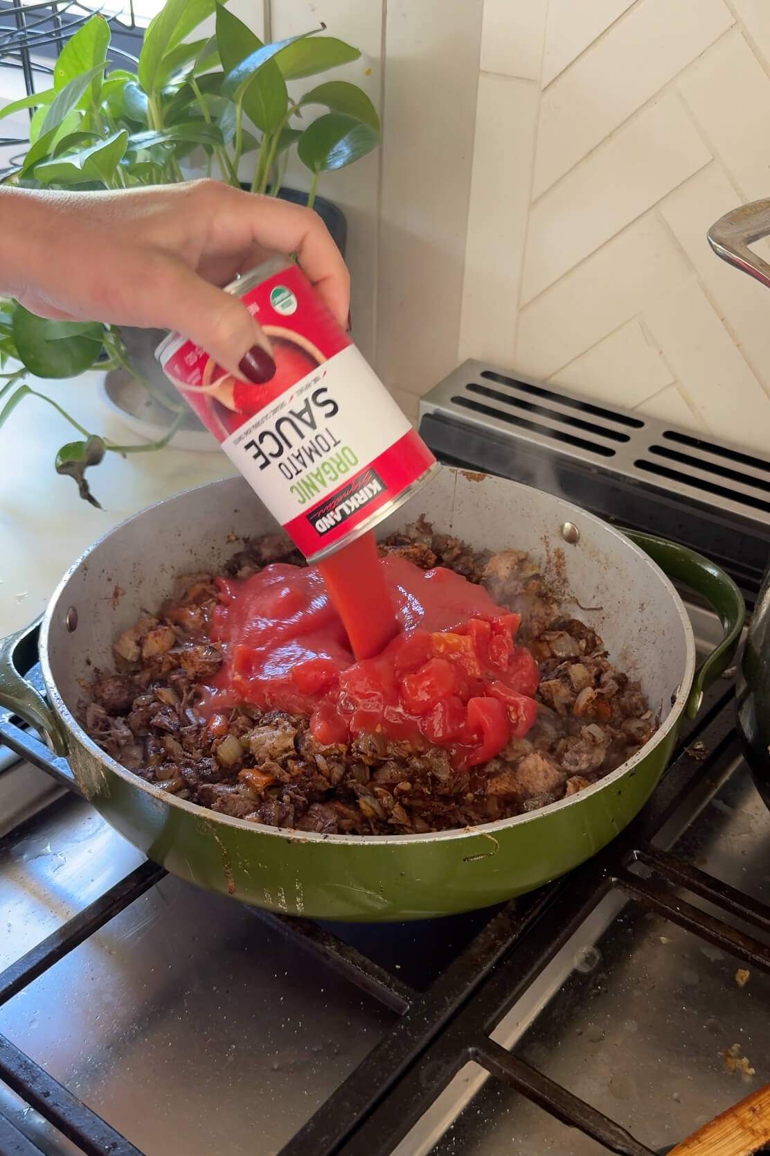 Adding tomato sauce and diced tomatoes to my brisket chili recipe.